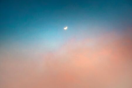 New Moon Over Pastel Colors Sunset Sky Background. Beautiful Skyscape. Tranquil View. の写真素材