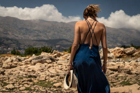 Back Side of a Beautiful Young Woman Standing on the Top of the Mountains. Enjoying Amazing...