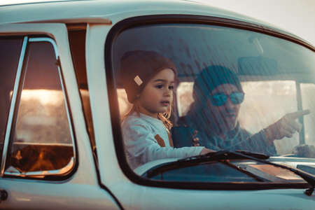 Father with his Little Baby Boy in the Car. Enjoying Road Trip Adventures. Active People. With Pleasure Spending Time Together. Happy Family Life.の写真素材