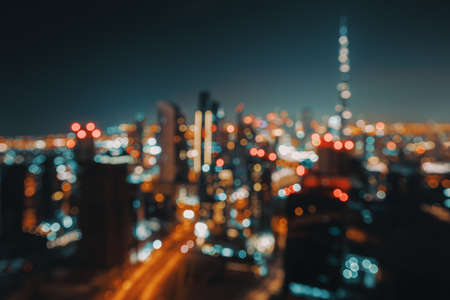 Blur Nighttime Cityscape. Abstract Background of an Urban Night Scene. Bokeh Lights. Modern City of Dubai. United Arab Emirates.の写真素材