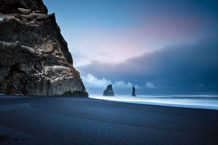 Beautiful Landscape of a Famous Black Pebbles Beach. Amazing View on the Basalt Cliffs in the Sea....