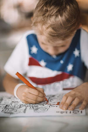 Nice Boy with Pleasure Drawing and Coloring. Children on Distance Education. Homework or Leisure Time. Schooling at Home.の写真素材