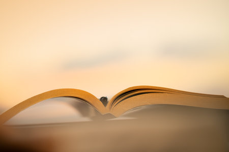 Spending a Nice Warm Evening Reading an Interesting Book Outdoors. Keep a Pen to Mark the Most Important Things. Calm Pleasant Pastime. Self Educationの写真素材