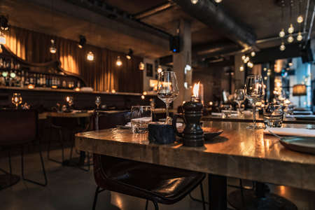 Cozy Evening in Luxury Restaurant. Beautiful Interior of Restaurant in Warm Mild Candlelight. Night...
