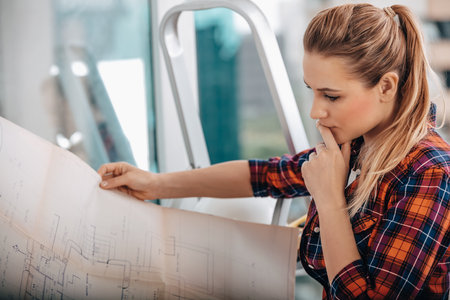 Portrait of a Serious Interior Architect. Woman Thinking about Apartment Design Plan. House Renovation.の写真素材