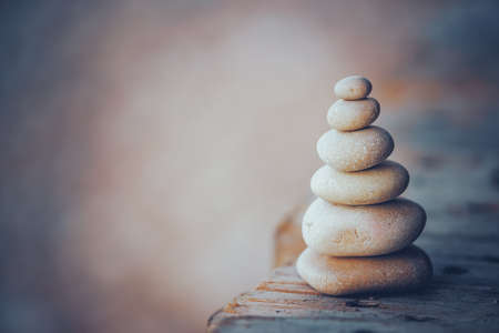 Conceptual Photo of Zen Balance. Pile of Pebbles on the Boardwalk on the Beach. Day Spa. Mind Body and Soul.の写真素材