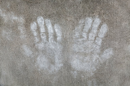 Conceptual Photo of a Charity, People Cooperation, Crime, Homeless Children, Hope, Security or SOS. Two Palms Shape on Stone Background.の写真素材