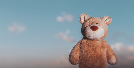 Cute bear toy over the sky backgroundの写真素材