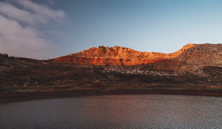 Peaceful sunset over lake landscapeの写真素材