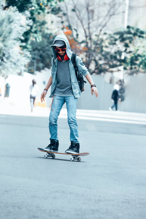 Teen boy on skateboard on the streetの写真素材