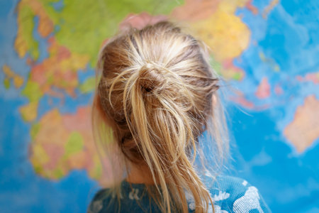 Little baby looking on the mapの写真素材