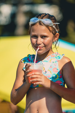Little girl drinking cocktail in aquaparkの写真素材