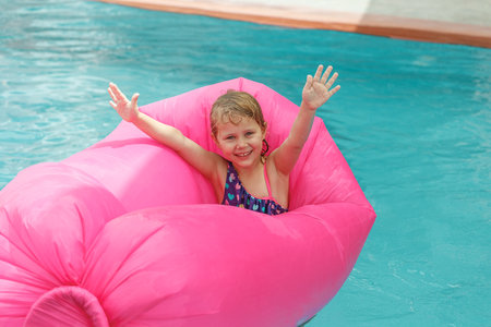 Happy little girl in the pool