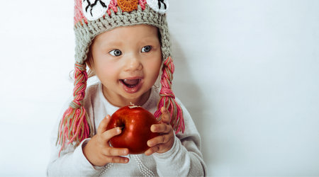 Little smiling girl with an appleの写真素材