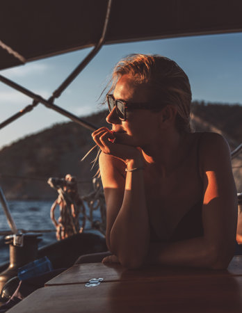 Attractive woman on the sailboatの写真素材