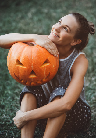 Pretty woman with Halloween pumpkin headの写真素材
