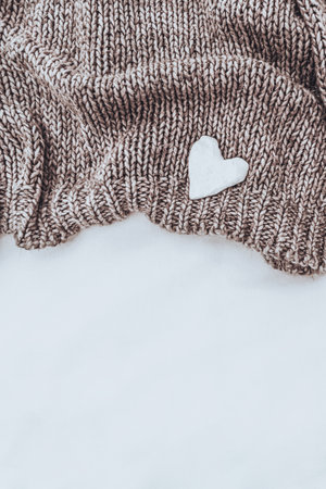Knitted Beige Pullover with Little White Heartの写真素材