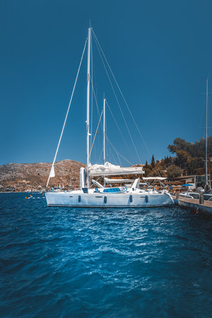 Gorgeous White Sailboat Moored in the Mediterranean Harborの写真素材