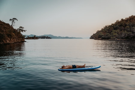 Sportive Guy Resting on the Sup Board