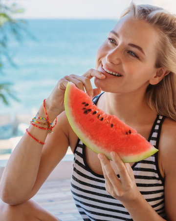 Happy Girl Eating Watermelon Outdoorsの写真素材
