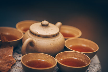 Traditional tea ceremony with a clay teapot and cups, celebrating Asian cultureの写真素材