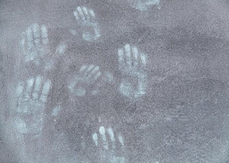 Handprints Imprinted on a Concrete Surface Backgroundの写真素材