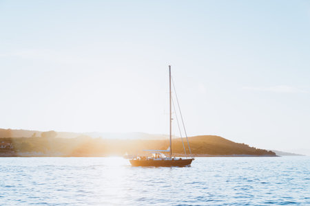 Serene Beauty of Sailing at Sunsetの写真素材