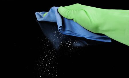  Hand with blue sponge isolated over black background 
の写真素材