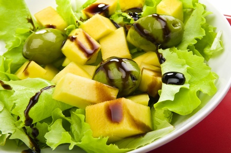 Green salad with mango and olivesの写真素材