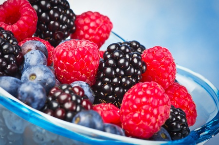 Glass with fresh berries on the whiteの写真素材