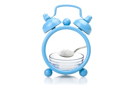 Old blue alarm clock concept close up on white 