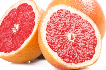 Pink grapefruit close up on the white の写真素材