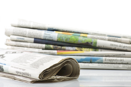 Pile of Various newspapers over white background