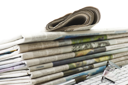 Pile of Various newspapers over white backgroundの写真素材