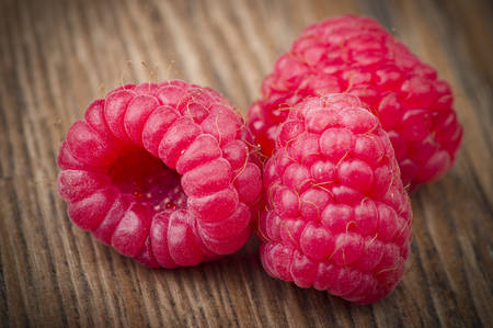 Fresh Raspberry close up on the wood table