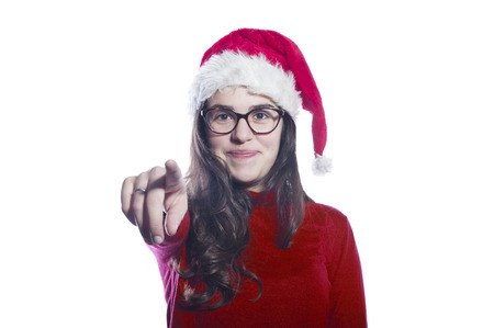 Portrait of a beautiful young woman wearing a santa hat smilingのeditorial素材