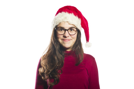 Portrait of a beautiful young woman wearing a santa hat smilingのeditorial素材