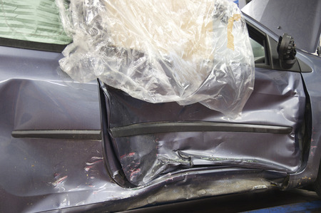 Crash car ready to be repaired in the workshopの写真素材