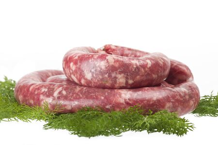 fresh raw meat sausages on white backgroundの写真素材