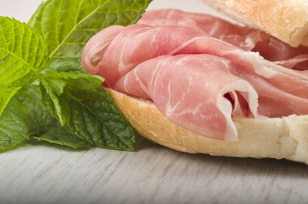 sandwich with Italian prosciutto crudo ,raw ham leg slicedの写真素材