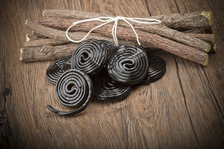 Licorice wheels candies close up on the woodの写真素材