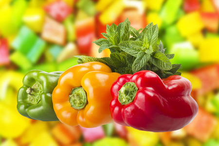 colored peppers close up over pepper backgroundの写真素材