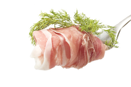 detail of sliced ham on a iron forkの写真素材