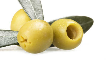 Pitted green olives close up on the whiteの写真素材