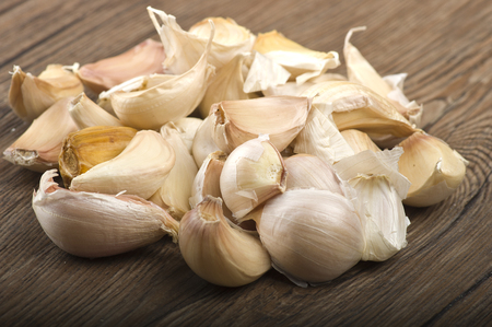 Group of garlic cloves on the woodの写真素材