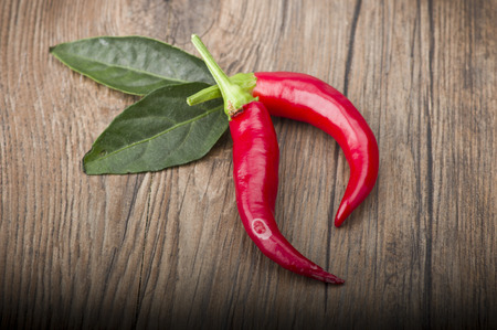Red chili pepper isolated on a wood backgroundの写真素材