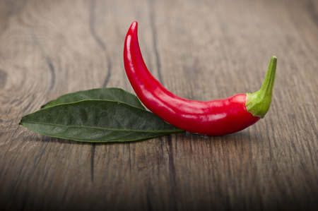 Red chili pepper isolated on a wood backgroundの写真素材