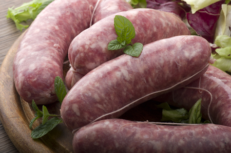 raw homemade sausage on a wooden boardの写真素材