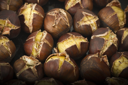 group of chestnuts on a wooden tableの写真素材