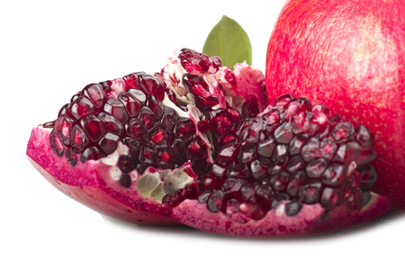 ripe pomegranate fruit and its grains on white backgroundの写真素材